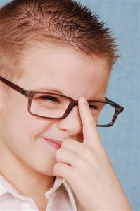 smart boy pushing up glasses