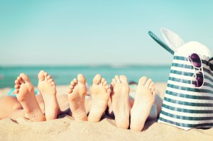 three women lying on the beach