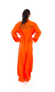 Rear view of a young Asian woman standing with arms akimbo in