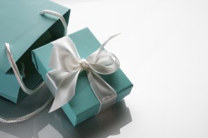 small turquoise box tied with a white ribbon and bag