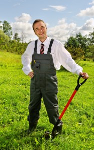 Young man with spade in a garden.