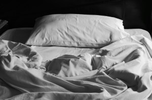 Messy white bed and pillow, in the morning