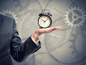 Concept of time with businessman that hold an alarm clock